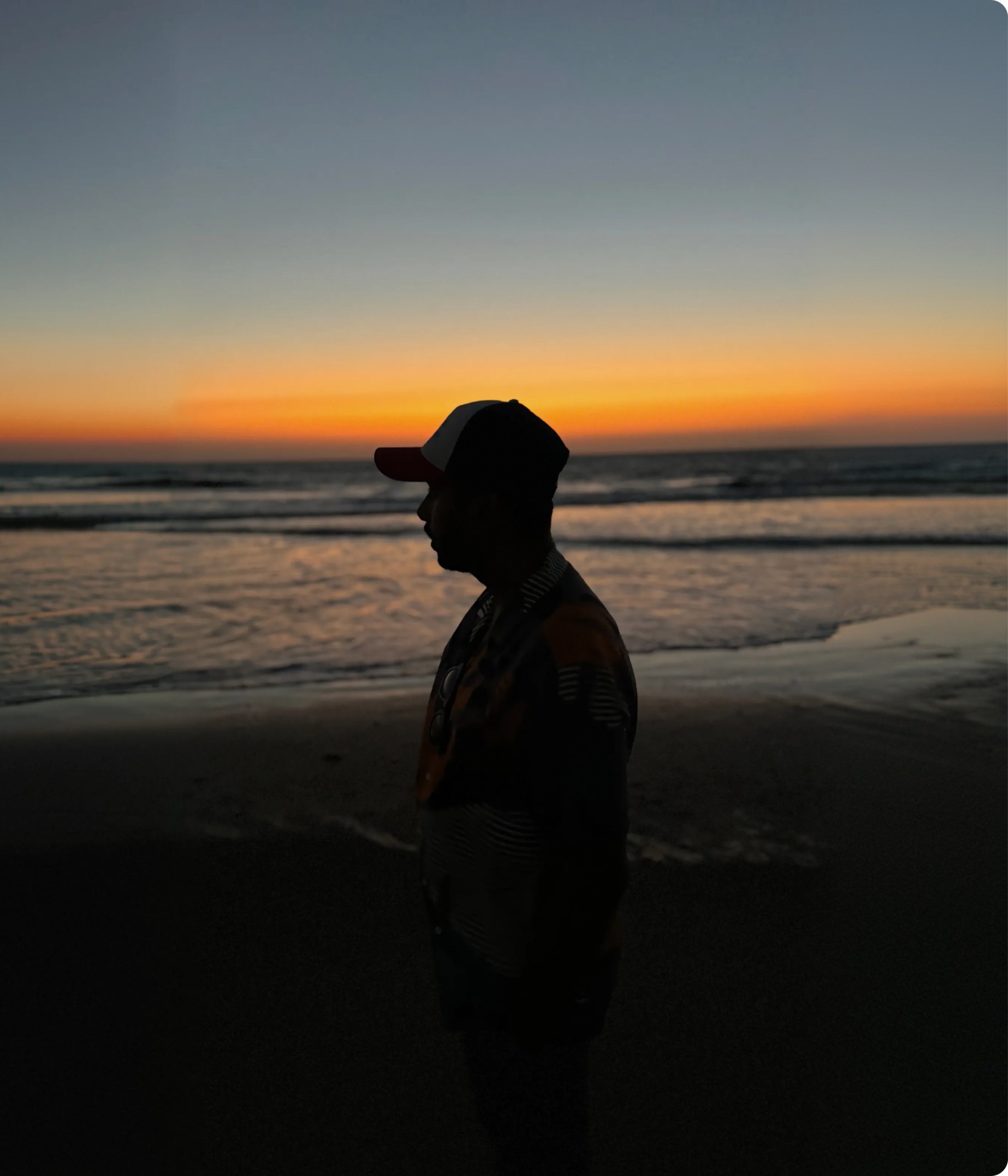 Sohan walking along a beach at sunset