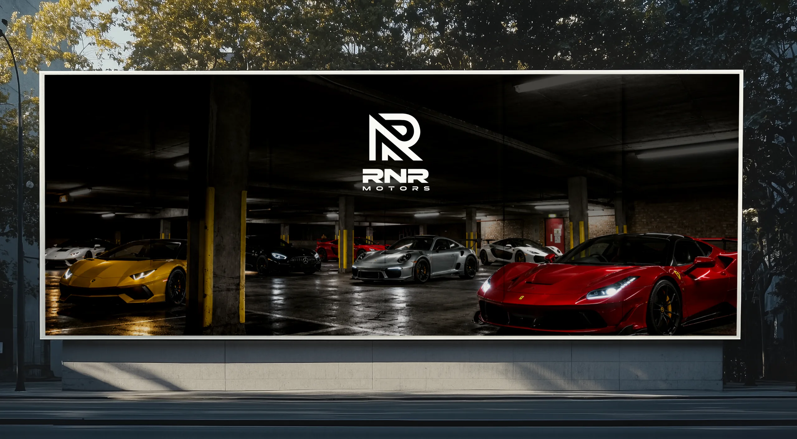 A roadside billboard in a car park full of supercars, carrying the RNR Motors logo
