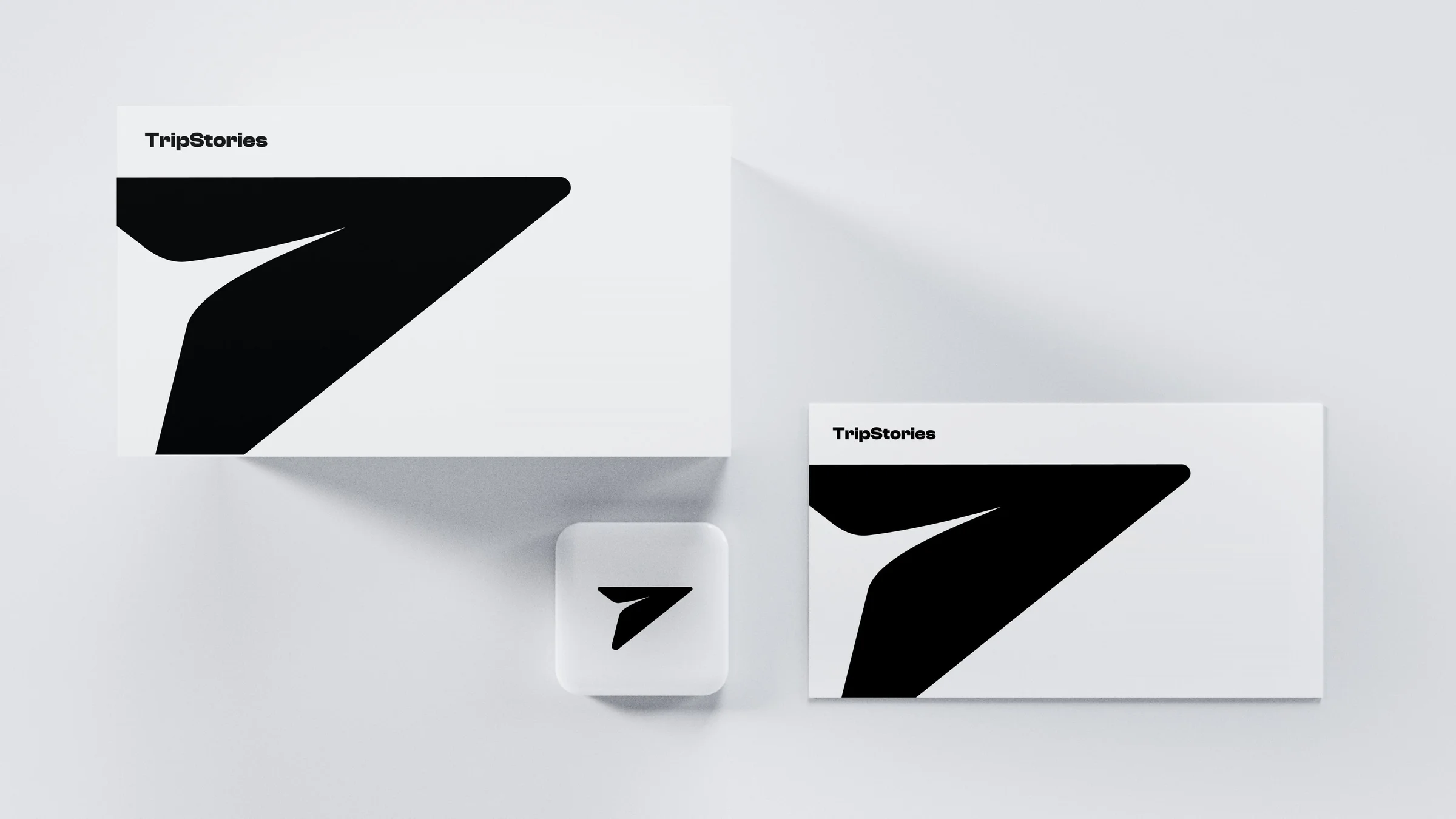 TripStories business cards in the white theme: a black mark on white with the app icon beside them